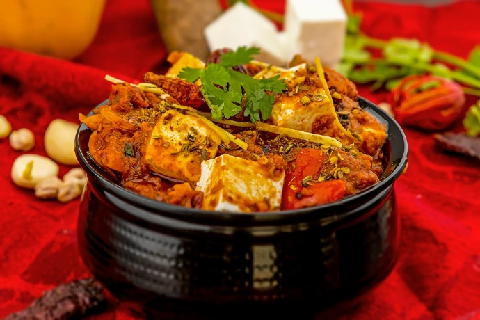 a bowl of food on a red table cloth